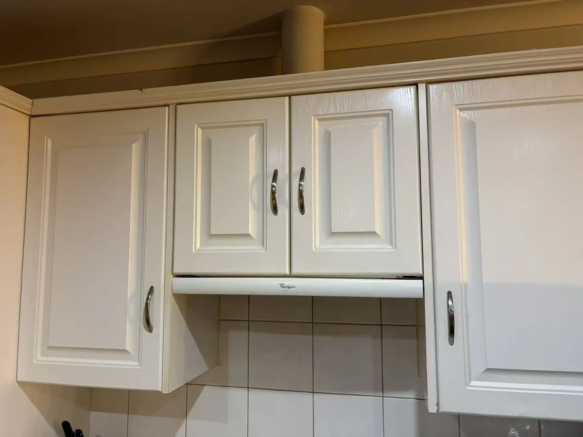 White kitchen cabinet doors refitted and aligned after repair